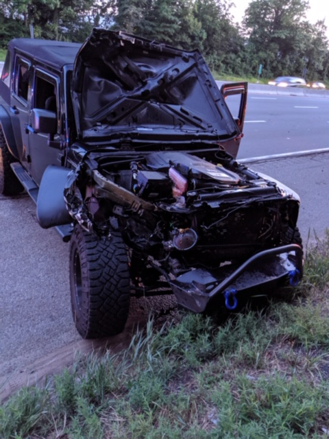Chiếc xe Jeep bị hư hỏng nặng phần đầu sau khi bị chiếc lốp xe tải tấn công.