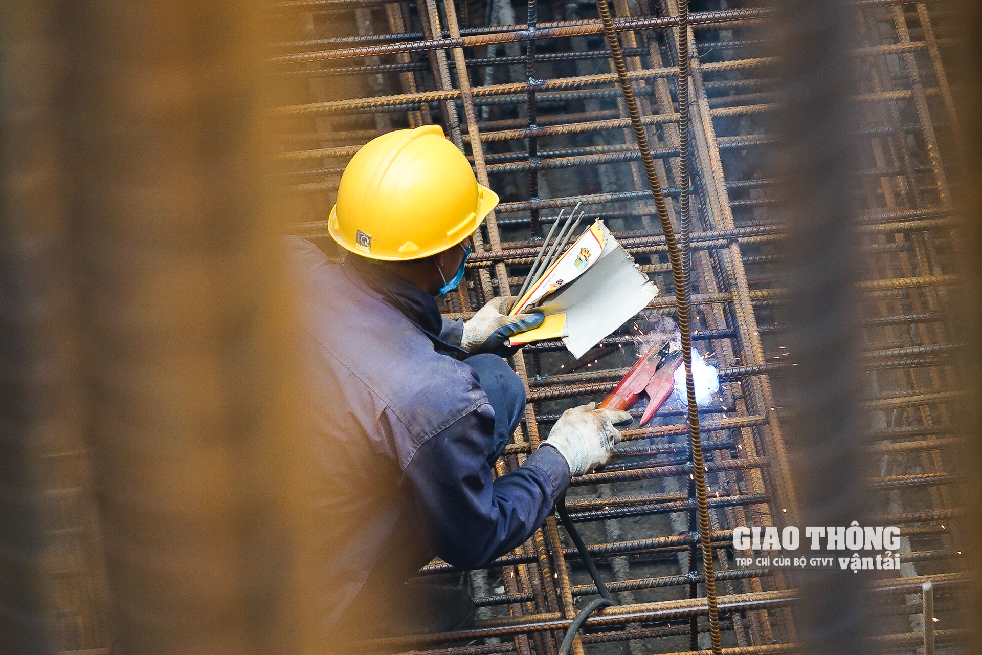 Một công nhân nhà thầu Trung Chính thi công hàn khung thép bên trong thân trụ cầu Vĩnh Tuy 2 ở giữa sông Hồng