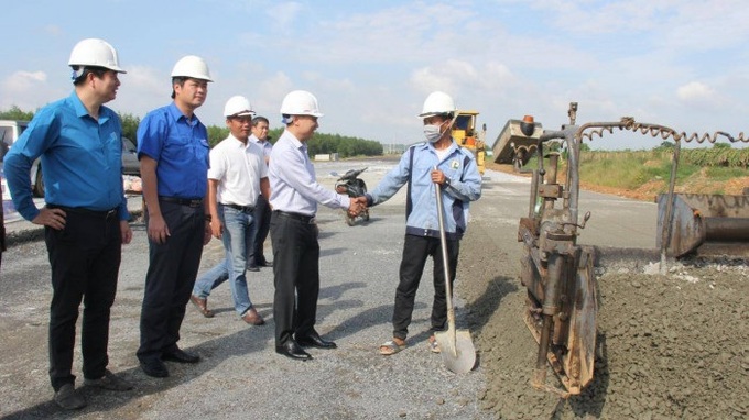 Ông Đào Văn Tiến, Phó Bí thư Thường trực Đảng ủy Bộ GTVT cùng đoàn công tác thăm hỏi một công nhân đang làm việc tại gói thầu XL01 cao tốc.