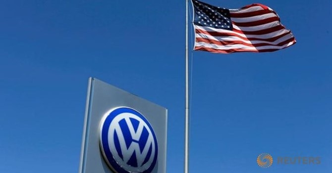 a-u-s-flag-flutters-in-the-wind-above-a-volkswagen