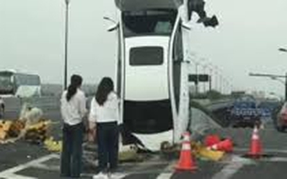 Nữ tài xế đâm ôtô dựng đứng ở cột biển báo