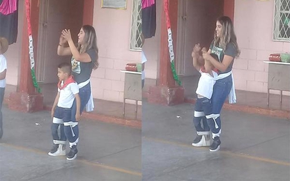 Cô giáo buộc chặt cậu bé vào người để tham gia nhảy cùng các bạn