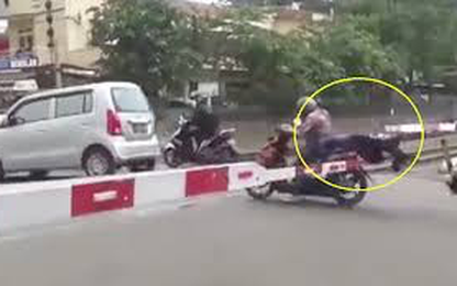 Cô gái ngồi sau xe máy đập mặt vào barie đường tàu